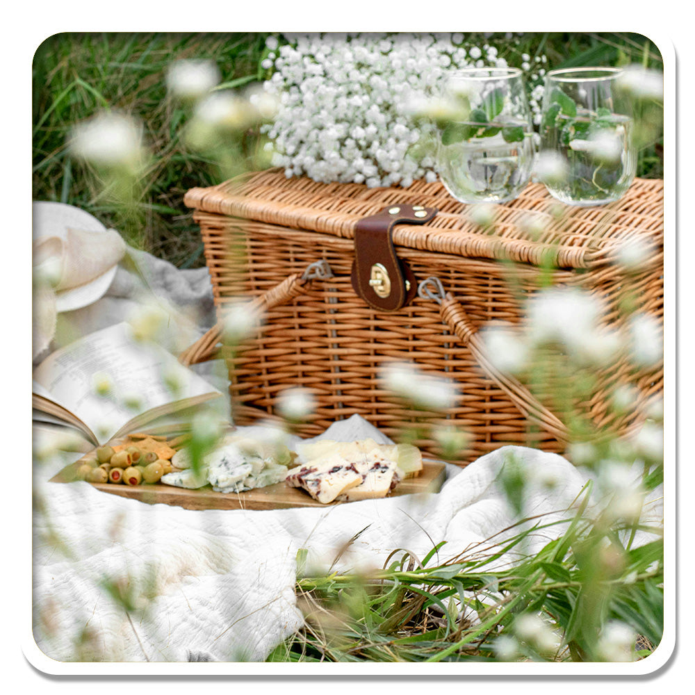Idyllic picnic setup with a wicker basket, embodying the serene lifestyle promoted by Lily & Loaf.