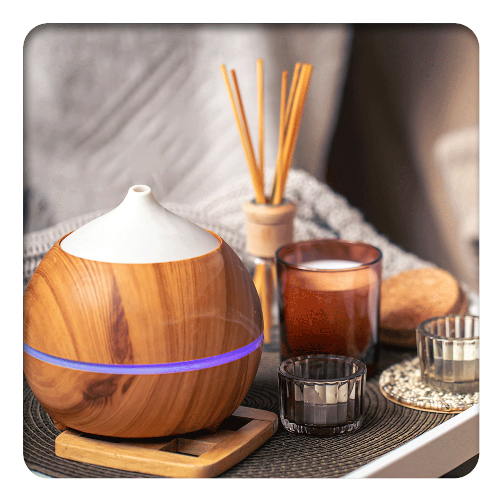 Aromatherapy diffuser with candles, creating a relaxing ambiance with Lily & Loaf's essential oils.