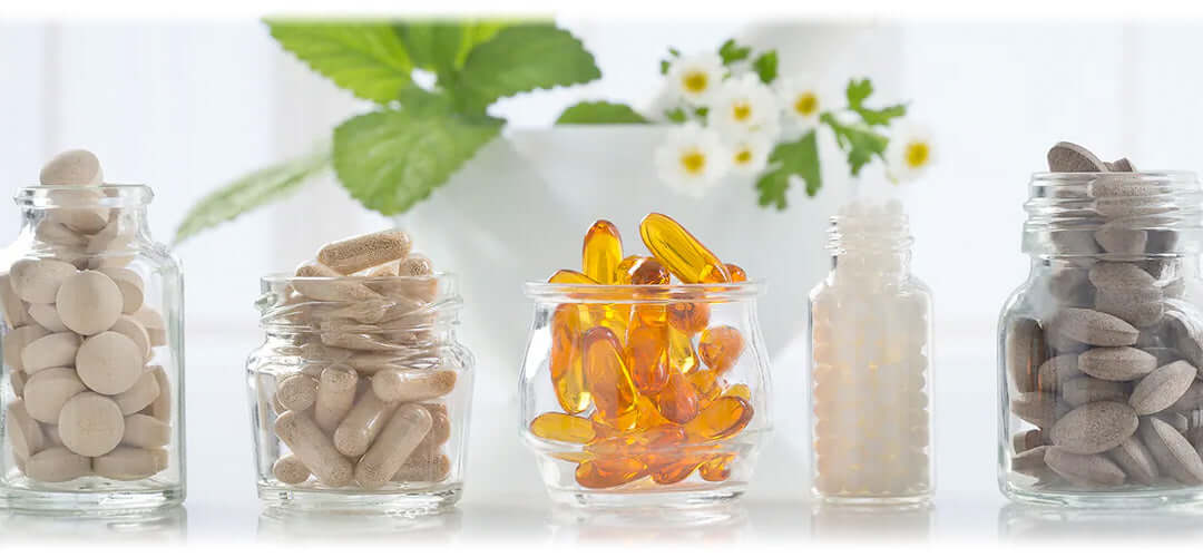Supplements for health and wellness, including vitamins and minerals, displayed on a table.