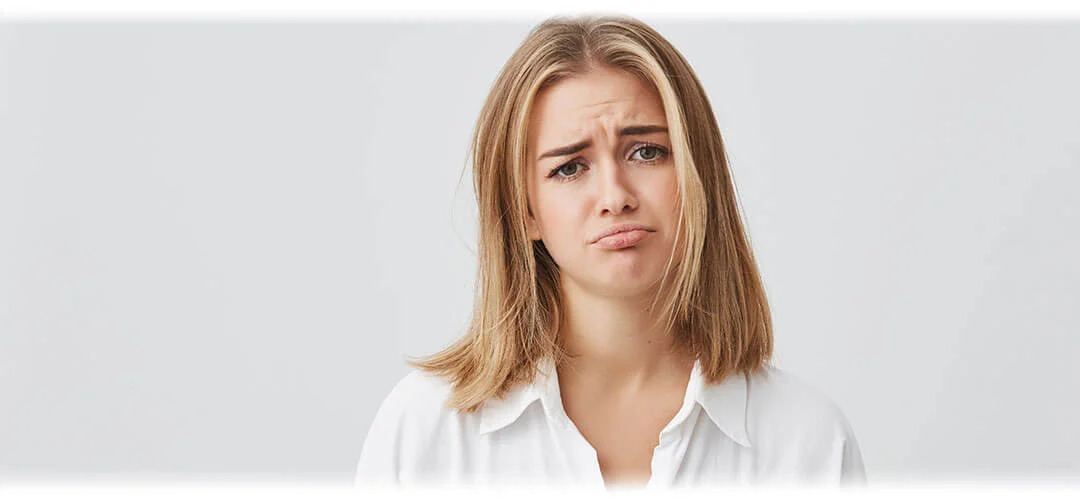 A woman with an unhappy face. The image suggests the concept of hormonal imbalance and its effects on health and well-being