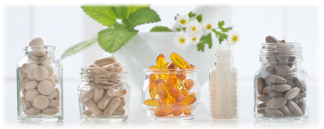 Glass Bottles withA close-up image of a handful of dried herbs and spices, showcasing their vibrant colors and textures. The assortment suggests high-quality ingredients for cooking or herbal remedies.Supplement tablets and capsules