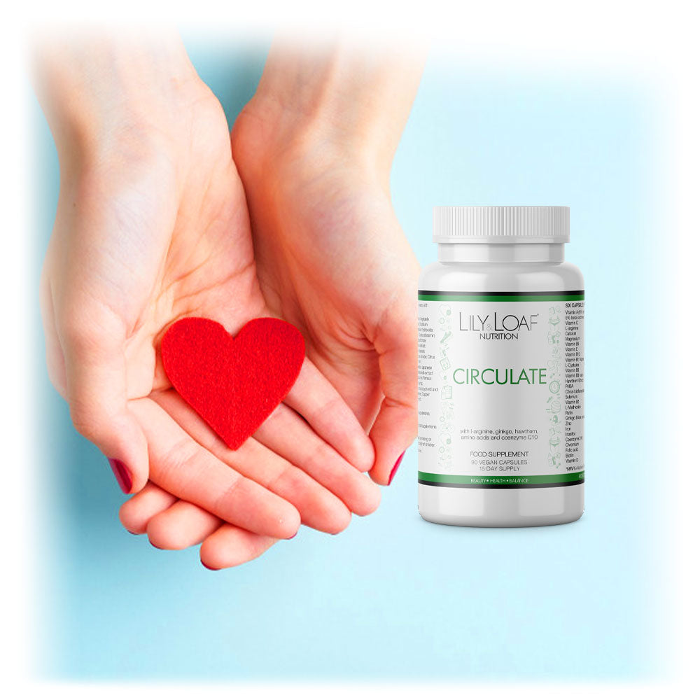 Hands cradling a felt heart beside a bottle of Lily & Loaf's Circulate supplement, signifying care for heart health.