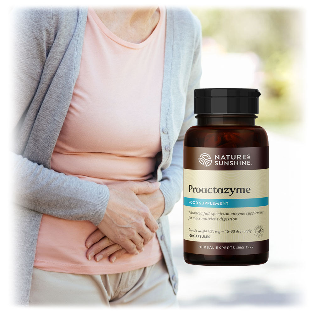 Woman experiencing stomach discomfort next to a bottle of Nature's Sunshine Proactazyme, available from Lily & Loaf, suggesting digestive aid.