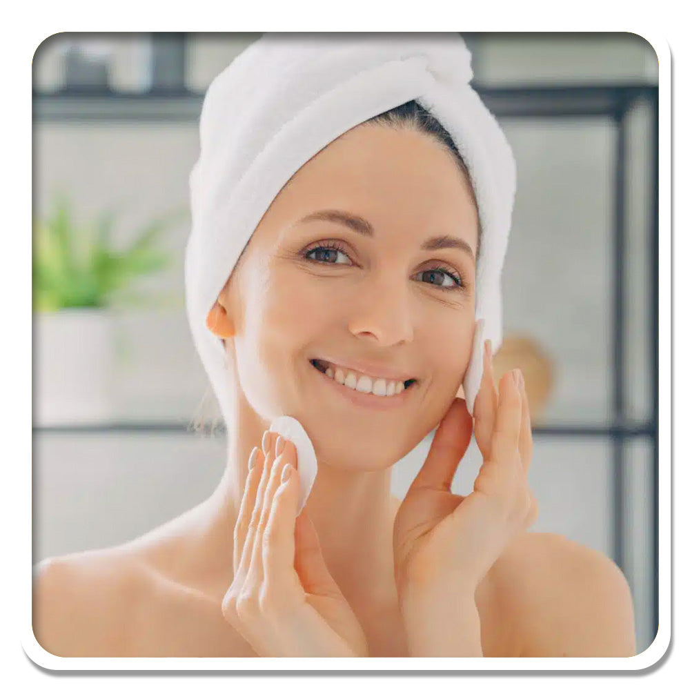 Woman with radiant skin using skincare, aligned with Lily & Loaf's natural beauty and self-care ethos.