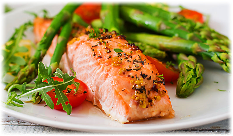 Healthy steamed pesto salmon with asparagus, a quick and nutritious meal.