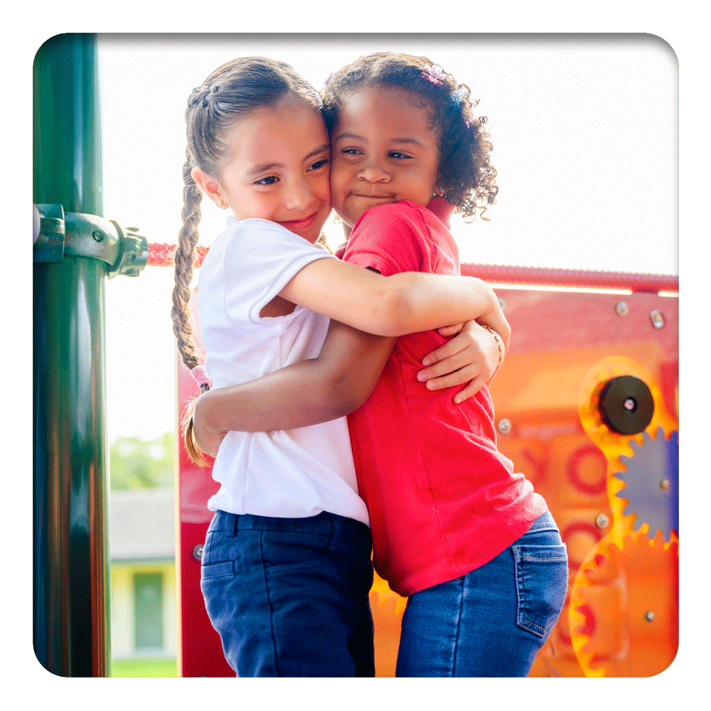 Two joyful children hugging, embodying the pure friendship supported by Lily & Loaf's holistic health philosophy.